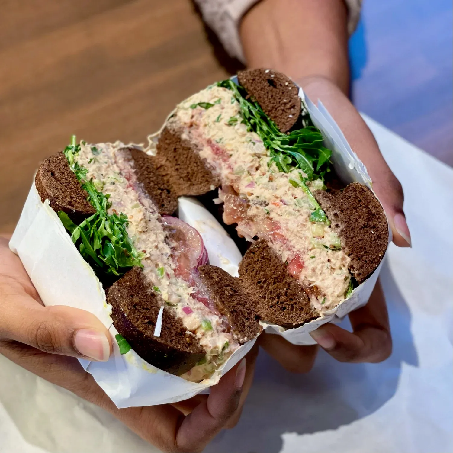 Cross-section of a tuna salad bagel sandwich