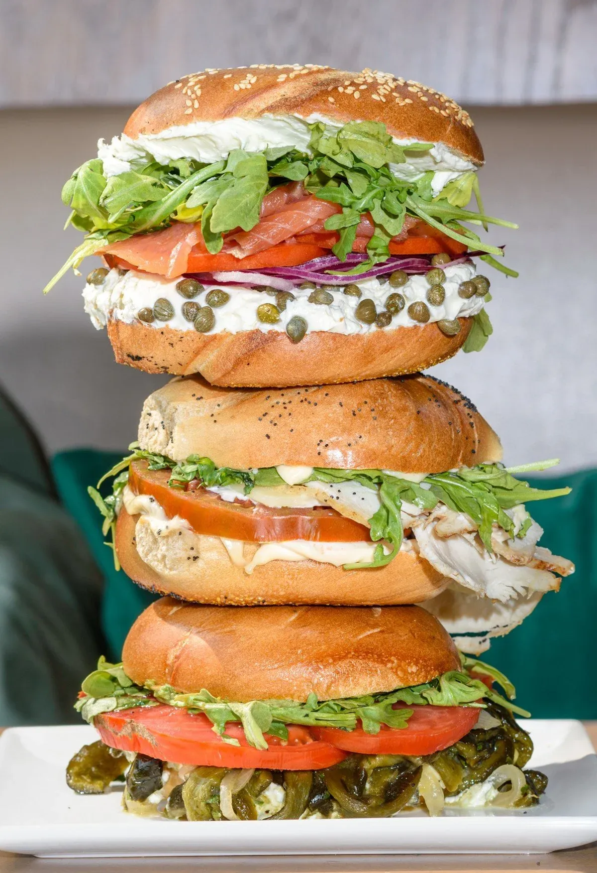 Three customized Gotham Bagels sandwiches stacked