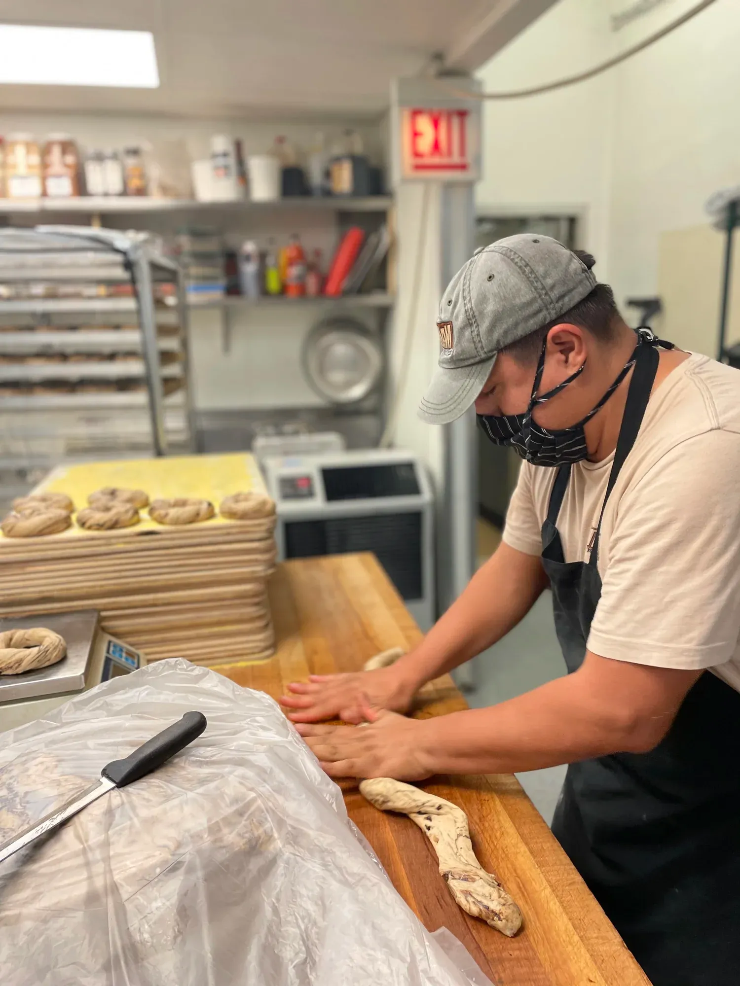Rolling cinnamon raisin dough at Gotham Bagels