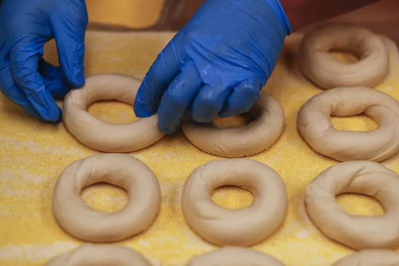 A cook adds water to plain bagel dough in the Gotham Bagels kitchen at 1212 N. Dearborn St. in Chicago
