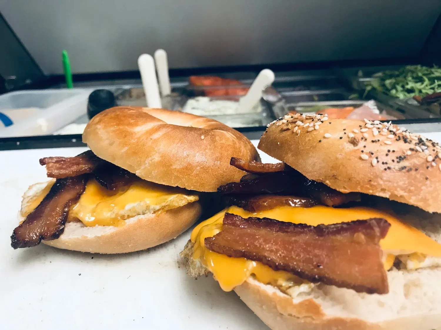 Two bacon egg and cheese bagel sandwiches