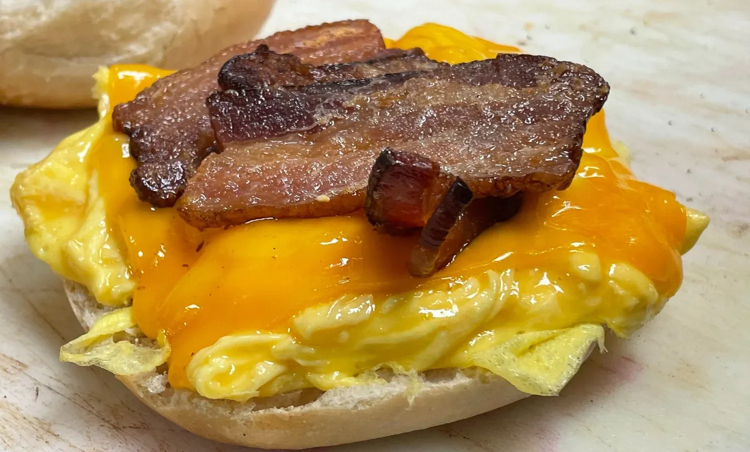 Bacon on a bagel sandwich with egg and cheese