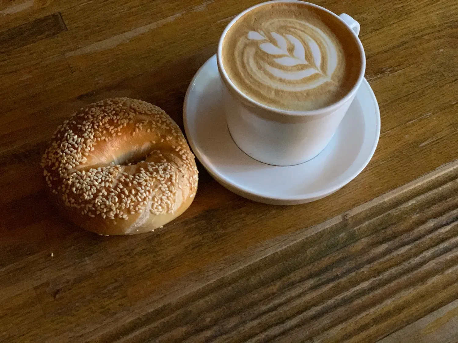 Sesame bagel paired with a latte