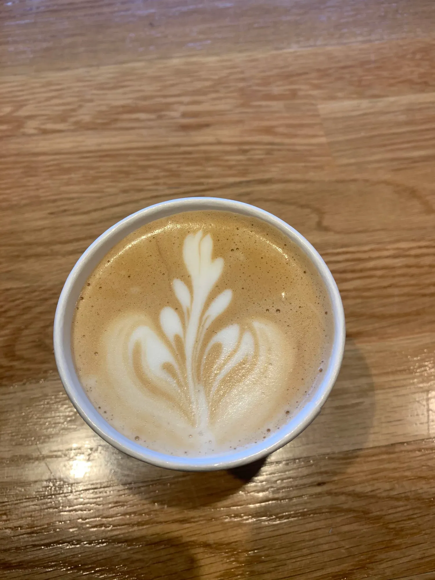 Latte art in a coffee cup at Gotham Bagels