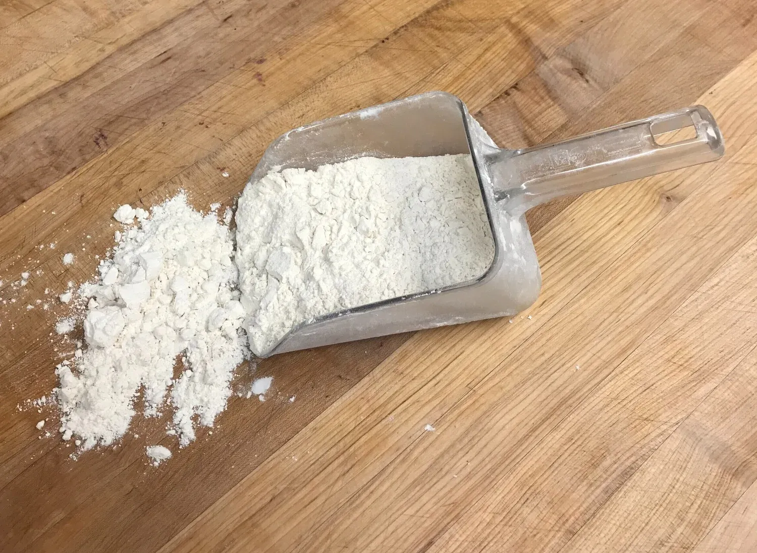 A scoop of flour on the table,A scoop of flour on the table